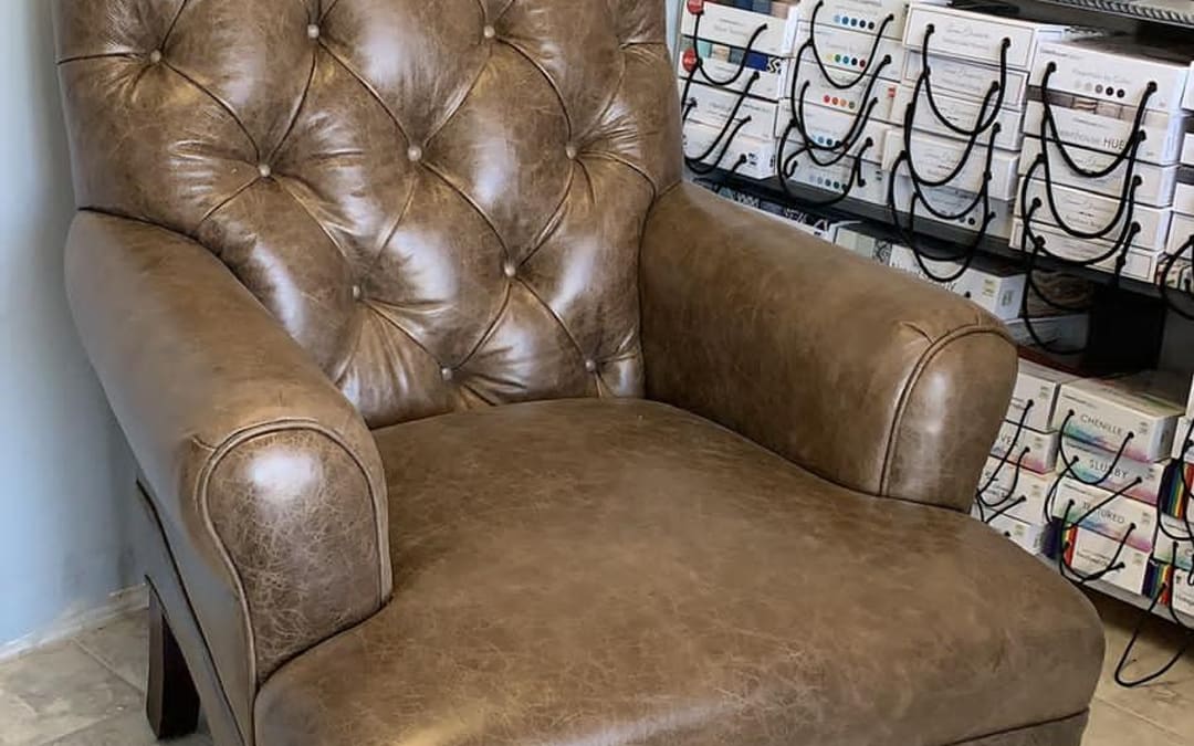 Tufted leather armchair restored by Capistrano Upholstery in the San Juan Capistrano workroom