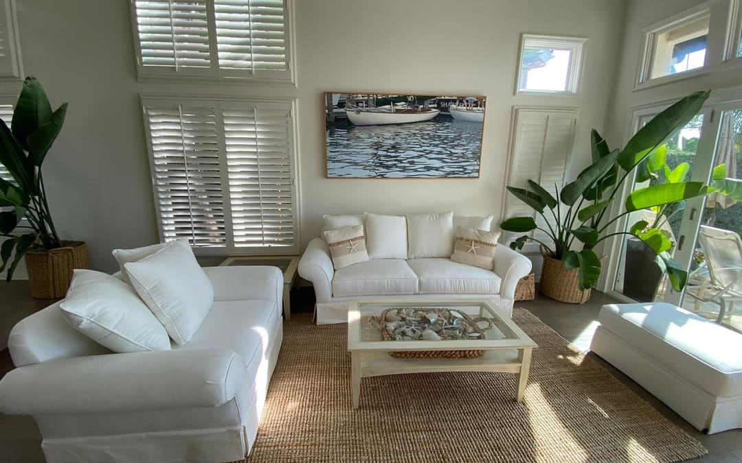 Coastal living room in Orange County with white slipcovered sofas upholstered by Capistrano Upholstery