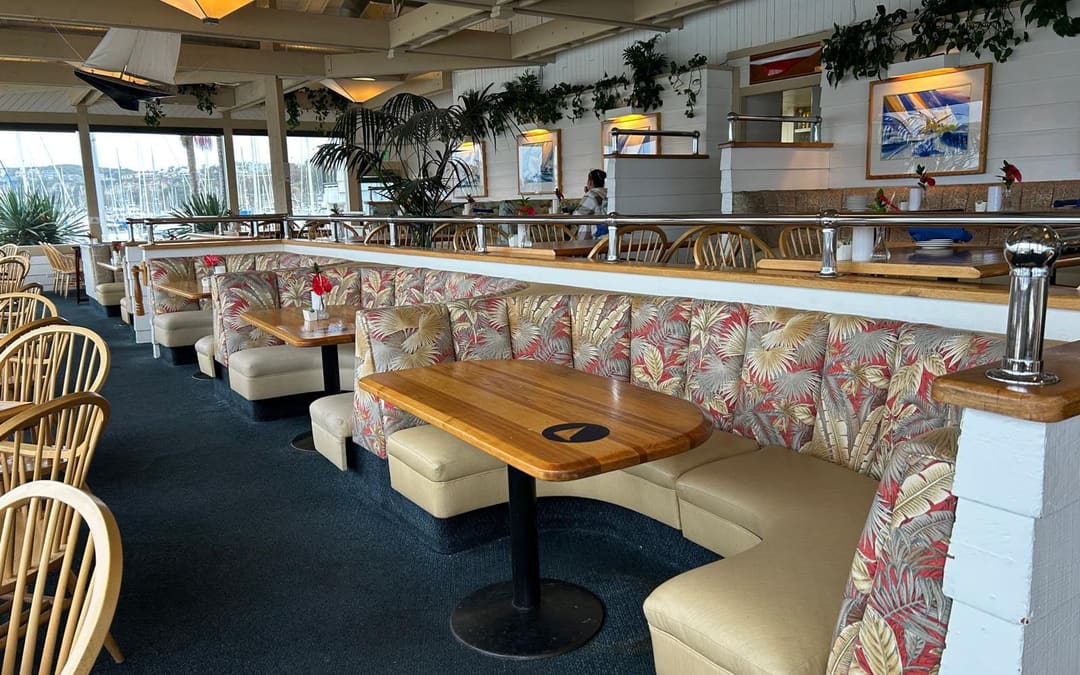 Wind & Sea dining room booths in Dana Point Harbor, rebuilt by Capistrano Upholstery with new seats and re-covered palm-leaf backs