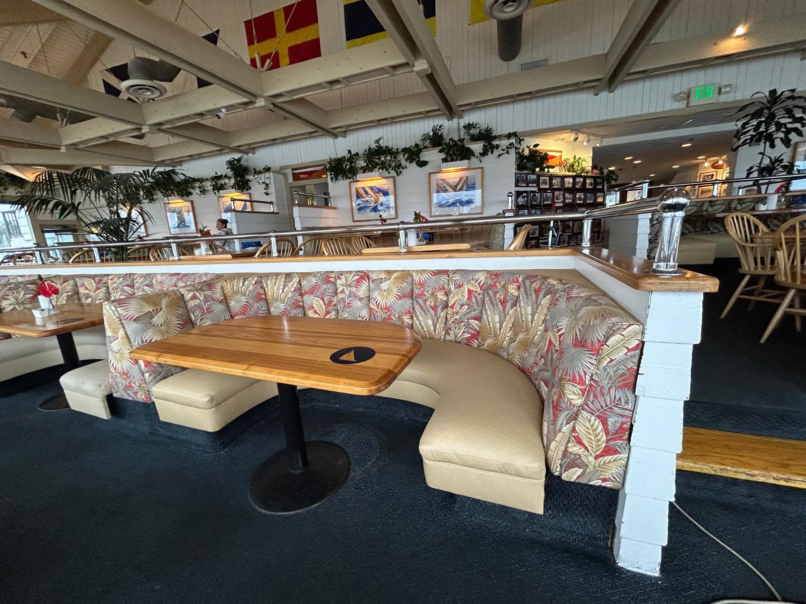 The finished Wind & Sea booths in daylight, with re-covered channeled backs and new cream seats